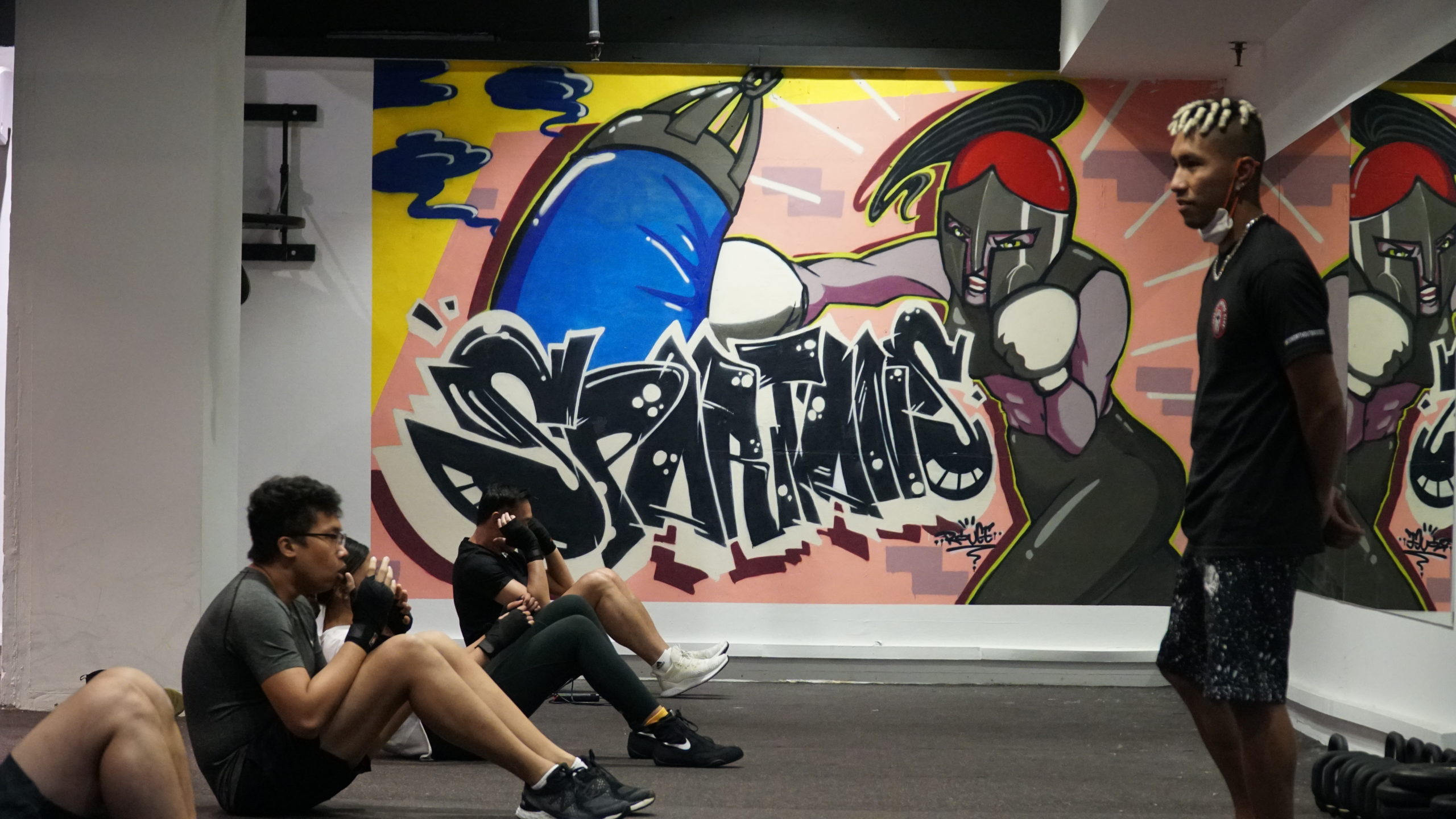dg core workout in front of mural